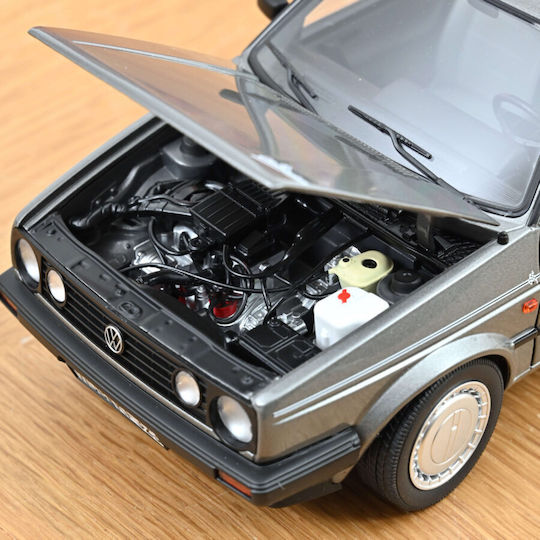 Machete Auto Volkswagen Golf Champion Grey Metallic 1989 1:18 Norev